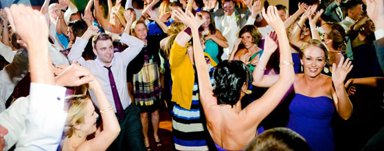 A group of people dancing at a party.